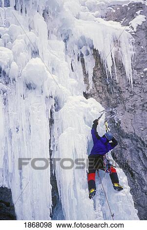Stock Photo - man ice climbing a frozen waterfall, marble canyon, marble canyon provincial park, british columbia, canada. Fotosearch