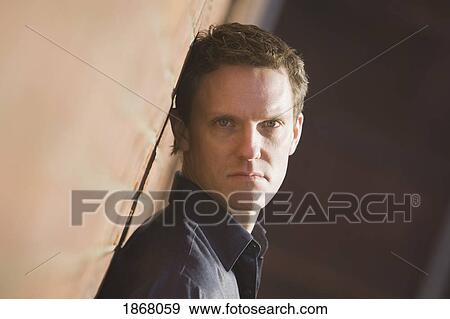 man leaning against a wall View Large Photo Image Stock Photo - man leaning against a wall. Fotosearch