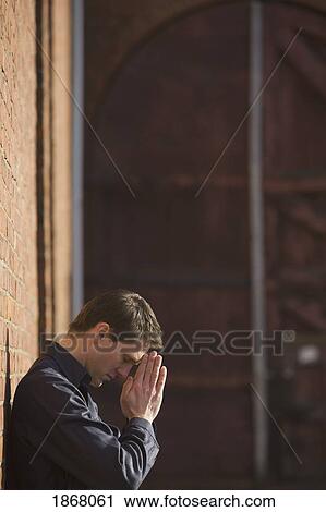 Stock Image - man praying. Fotosearch