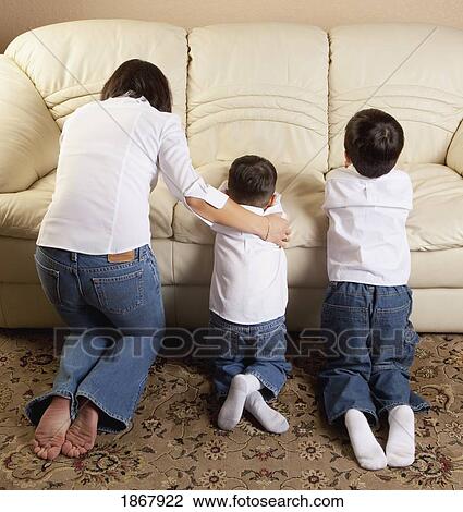 Stock Image - mother praying with her sons. Fotosearch