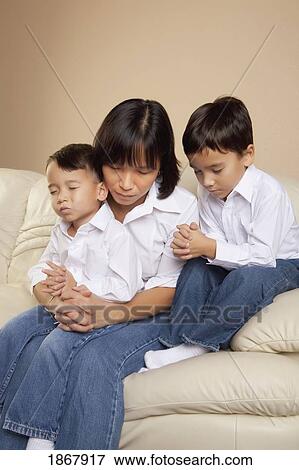 mother praying with her sons View Large Photo Image Stock Photo - mother praying with her sons. Fotosearch