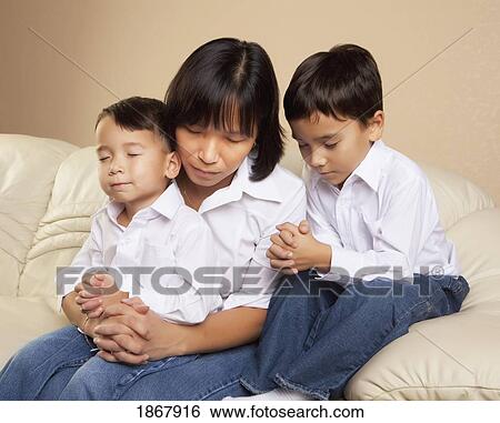 mother praying with her sons View Large Photo Image Stock Photograph - mother praying with her sons. Fotosearch