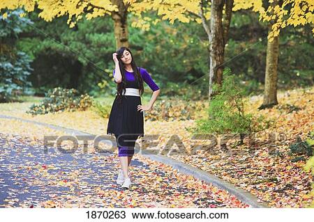 Stock Image - portland, oregon, united states of america; a teenage girl walking down the street in autumn. Fotosearch