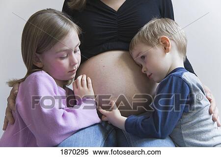 pregnant woman surrounded by her young daughter and son View Large Photo Image Stock Photography - pregnant woman surrounded by her young daughter and son. Fotosearch