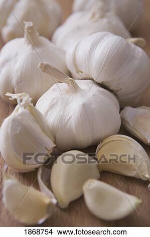 Picture - raw garlic bulbs and cloves. Fotosearch