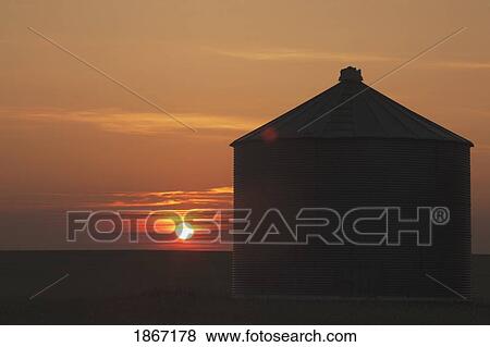 Silhouette of grain bin at sunrise View Large Photo Image Stock Photo - Silhouette of grain bin at sunrise. Fotosearch
