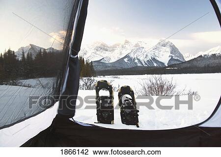 Stock Image - Snowshoes seen from interior of tent, Kananaskis Country, Alberta, Canada. Fotosearch