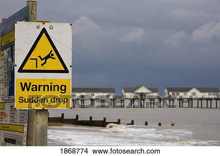 southwold, suffolk, england; sign of warning and a sudden drop posted on the beach View Large Photo Image Picture - southwold, suffolk, england; sign of warning and a sudden drop posted on the beach. Fotosearch
