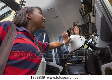 student and school bus driver slapping hands in a 'high five' View Large Photo Image Stock Photo - student and school bus driver slapping hands in a 'high five'. Fotosearch