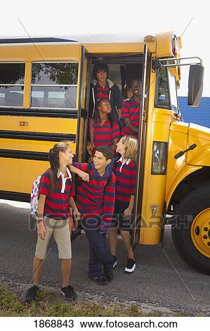 Stock Image - students getting off the school bus. Fotosearch
