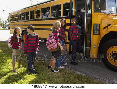 Stock Photo - students getting on the school bus. Fotosearch