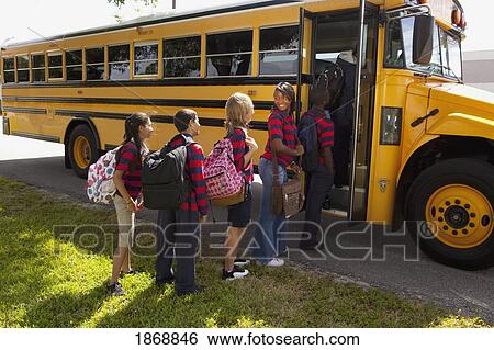 Stock Photograph - students getting on the school bus. Fotosearch