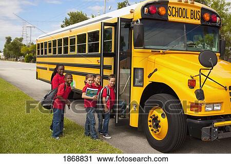 Stock Image - students lining up to get on the school bus. Fotosearch