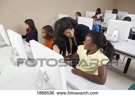 students working on computers with their teacher View Large Photo Image Stock Photograph - students working on computers with their teacher. Fotosearch