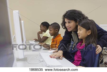 teacher helping student on the computer View Large Photo Image Stock Photography - teacher helping student on the computer. Fotosearch