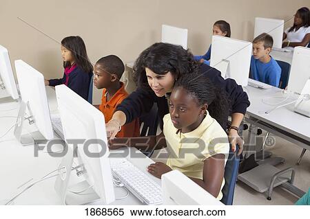 teacher helping students in computer class View Large Photo Image Stock Photography - teacher helping students in computer class. Fotosearch