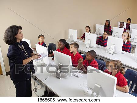 Stock Photography - teaching a computer class. Fotosearch