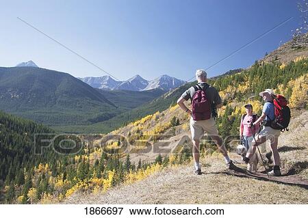 Stock Photo - Three hikers on a mountain trail. Fotosearch