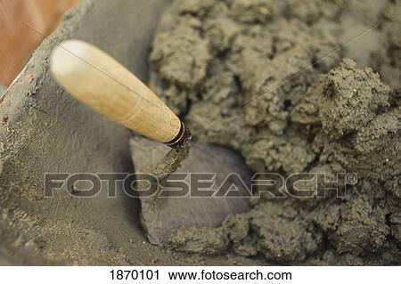Stock Image - trowel in the wet cement. Fotosearch