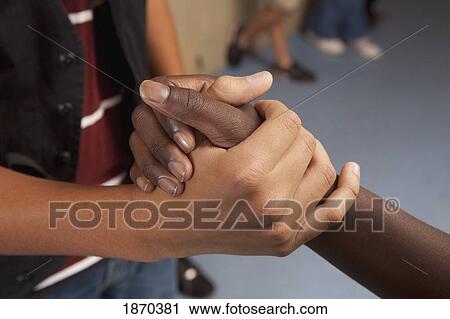Stock Image - two hands clasped. Fotosearch