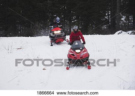 Picture - Two snowmobiles on a trail. Fotosearch