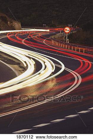 Stock Image - vehicle lights on a road. Fotosearch