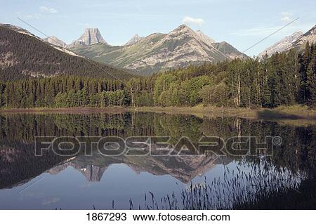 wedge pond with fortress mountain in the distance, kananskis country, alberta, canada View Large Photo Image Stock Image - wedge pond with fortress mountain in the distance, kananskis country, alberta, canada. Fotosearch