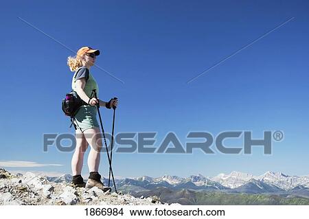 Woman hiking on a mountain top and enjoying the view View Large Photo Image Picture - Woman hiking on a mountain top and enjoying the view. Fotosearch