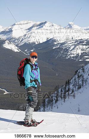 Stock Photo - Woman on snowshoes in the mountains. Fotosearch