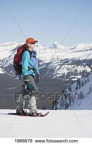 Stock Photo - Woman on snowshoes in the mountains. Fotosearch