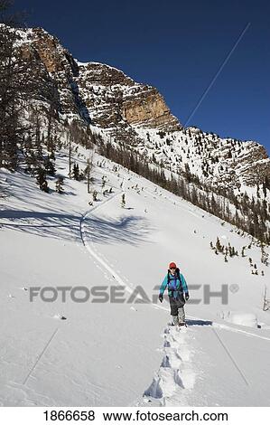 Woman on snowshoes View Large Photo Image Stock Photo - Woman on snowshoes. Fotosearch