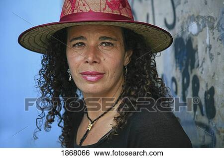 Stock Photograph - woman wearing a hat, caminito district, buenos aires, argentina. Fotosearch