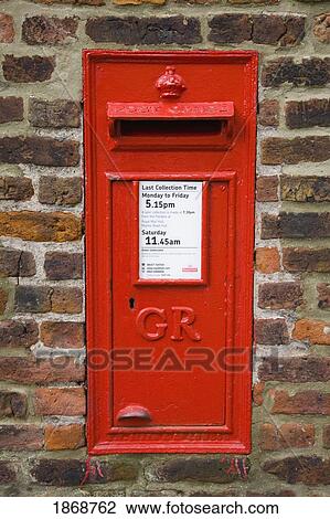 Stock Image - woolacombe, devon, england; red mailbox mounted in a brick wall. Fotosearch