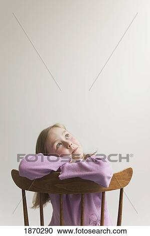 young girl with crossed arms on a wooden chair View Large Photo Image Stock Image - young girl with crossed arms on a wooden chair. Fotosearch