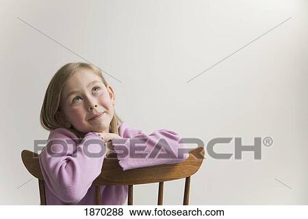 young girl with crossed arms on a wooden chair View Large Photo Image Stock Photo - young girl with crossed arms on a wooden chair. Fotosearch