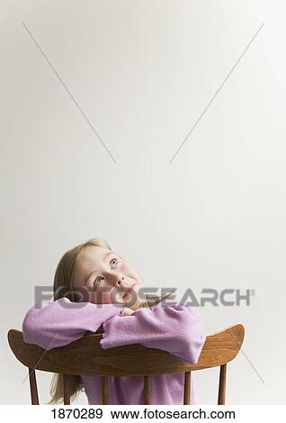 young girl with crossed arms on wooden chair View Large Photo Image Stock Photo - young girl with crossed arms on wooden chair. Fotosearch