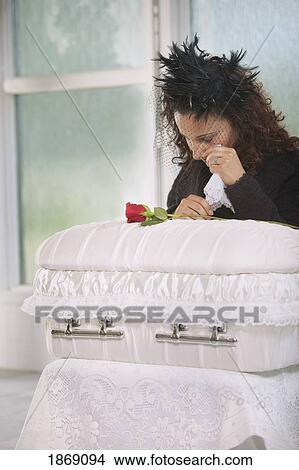 young mother grieving at an infant's coffin View Large Photo Image Picture - young mother grieving at an infant's coffin. Fotosearch