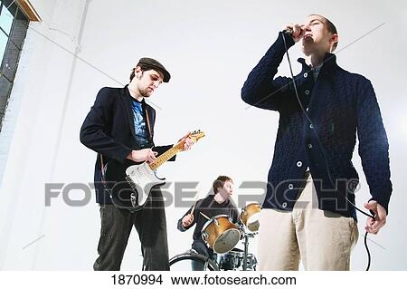 a band with a singer, drummer and electric guitar player View Large Photo Image Picture - a band with a singer, drummer and electric guitar player. Fotosearch