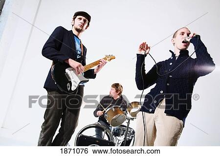 a band with a singer, drummer and electric guitar player View Large Photo Image Stock Photograph - a band with a singer, drummer and electric guitar player. Fotosearch