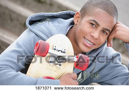 Stock Image - a boy with a skateboard. Fotosearch