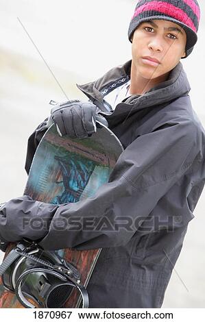 Stock Photo - a boy with a snowboard. Fotosearch