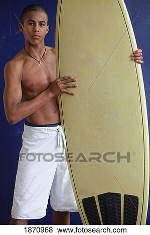 Stock Photo - a boy with a surfboard. Fotosearch