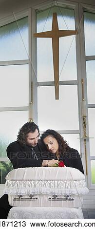 a couple grieving at an infant's coffin View Large Photo Image Stock Image - a couple grieving at an infant's coffin. Fotosearch