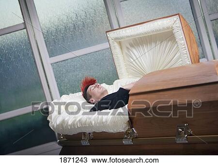 Stock Image - a deceased young man in a coffin. Fotosearch