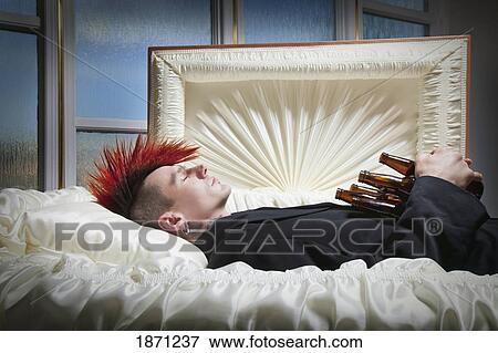 a deceased young man in a coffin holding beer bottles View Large Photo Image Stock Photo - a deceased young man in a coffin holding beer bottles. Fotosearch