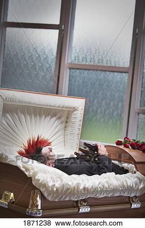 a deceased young man in a coffin holding beer bottles View Large Photo Image Stock Photo - a deceased young man in a coffin holding beer bottles. Fotosearch