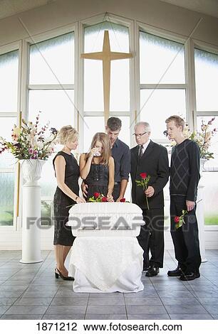 Stock Image - a family gathered around an infant's coffin. Fotosearch