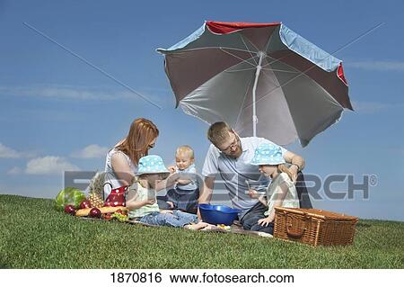 a family having a picnic View Large Photo Image Stock Photograph - a family having a picnic. Fotosearch