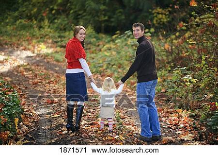 a family walking down a path in autumn View Large Photo Image Stock Image - a family walking down a path in autumn. Fotosearch
