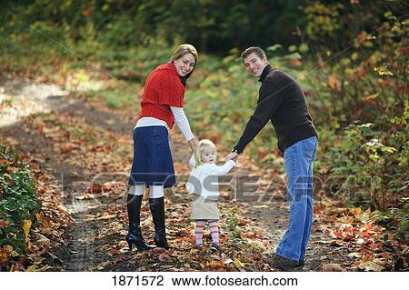 a family walking down a path in autumn View Large Photo Image Stock Image - a family walking down a path in autumn. Fotosearch